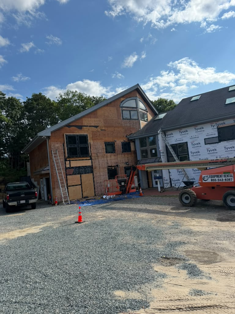 Large home under full exterior renovation with new sheathing and windows