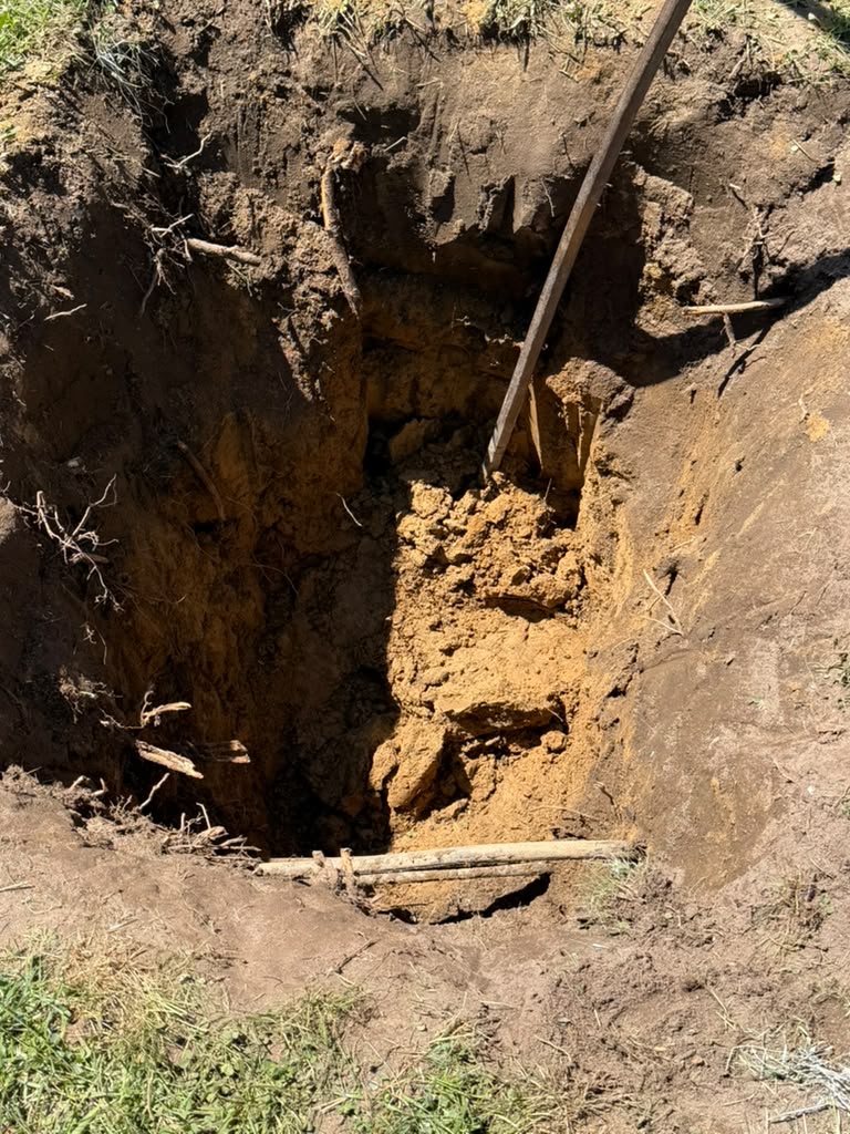 Excavated footing trench dug into the ground for new foundation work