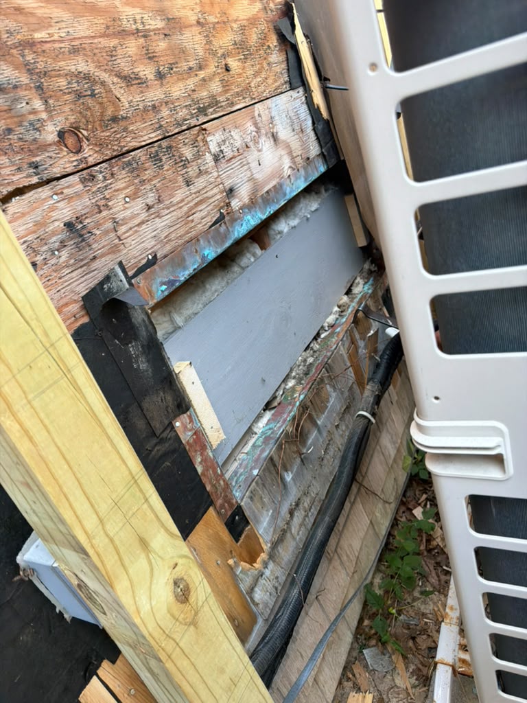 Exterior wall opened up with siding and old sheathing removed before repair